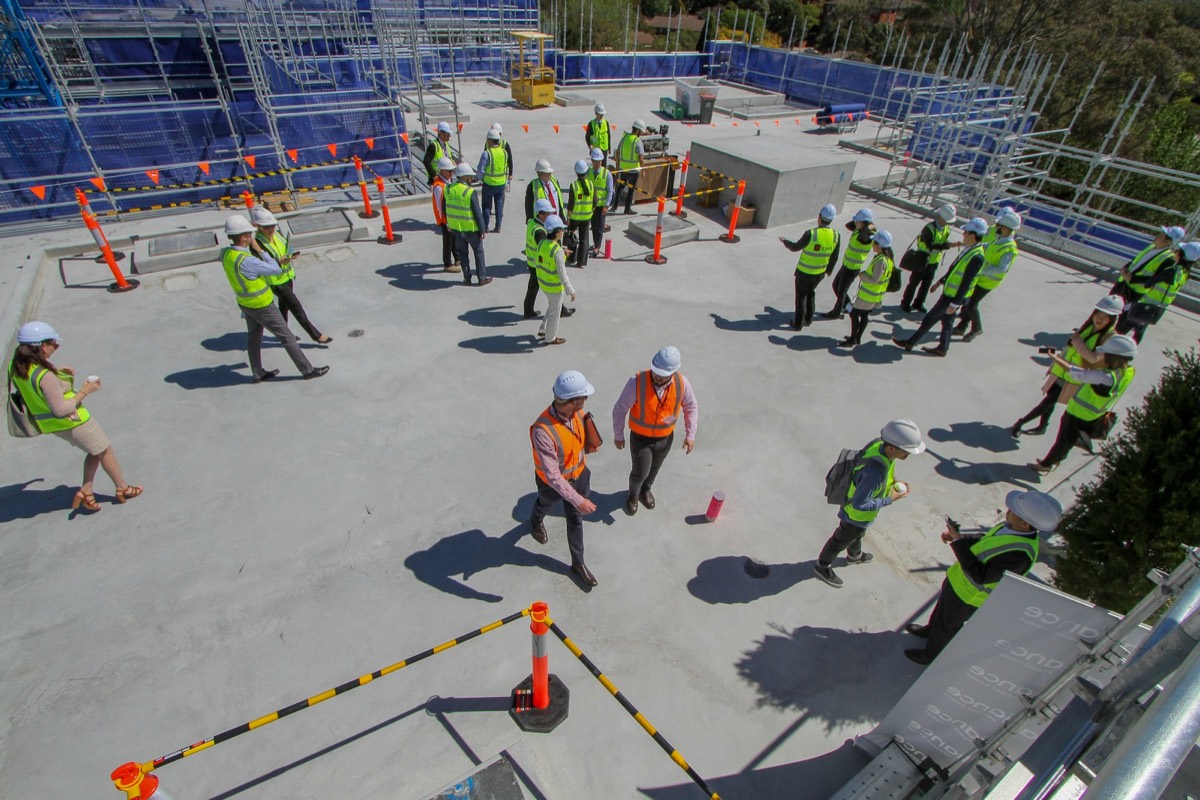 Aerial view of a construction crew in hi-vis vests on a building site