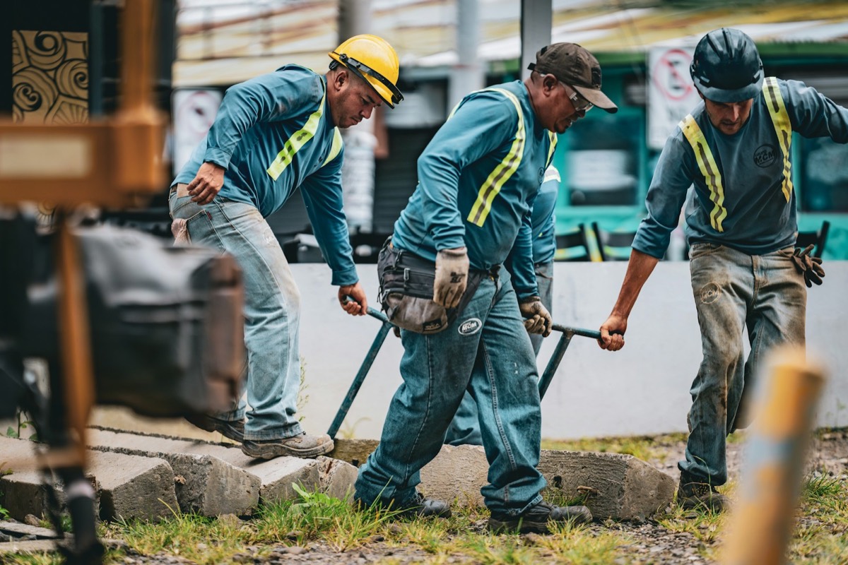 Workers in hard hats laying railway track